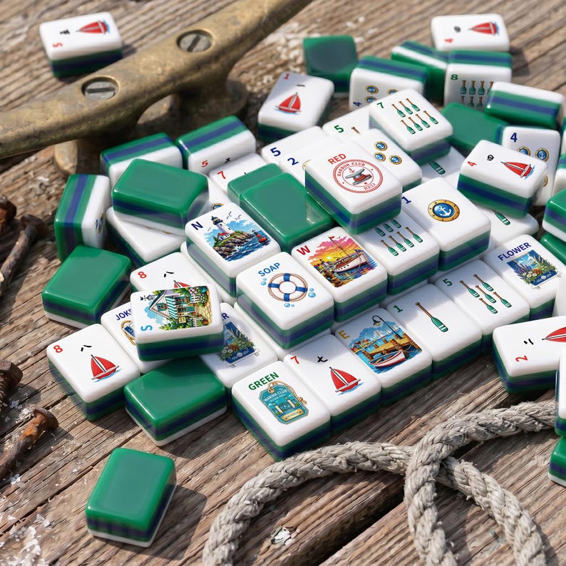 May include: A collection of white and green mahjong tiles featuring nautical illustrations, including sailboats, lighthouses, life preservers, and bottles. The tiles display various numbers, letters, and the text RED HARBOR CLUB, SOAP, and GREEN.