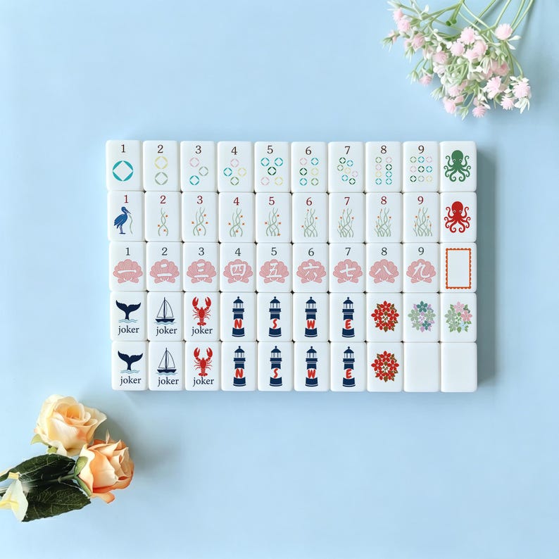 May include: A set of white Mahjong tiles with various symbols and numbers. The tiles feature illustrations of an octopus, a lobster, a lighthouse, and floral designs. The numbers 1-9 are displayed on the tiles.