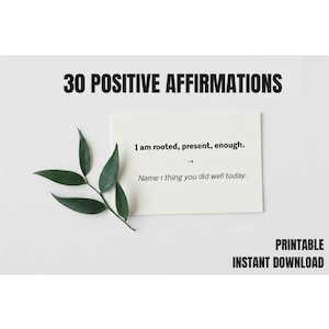 May include: A white card with the text "I am rooted, present, enough." and "Name 1 thing you did well today." is displayed. The words "30 POSITIVE AFFIRMATIONS" and "PRINTABLE INSTANT DOWNLOAD" are also visible. A sprig of green leaves is on the left.