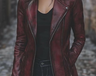 May include: A burgundy leather jacket with a classic asymmetrical zip closure, featuring a notched collar and multiple zippered pockets. The jacket is worn over a black top and dark wash jeans, creating a stylish, edgy look.