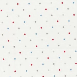 May include: White fabric with a repeating pattern of red, blue, and gray polka dots. The dots are evenly spaced across the surface. A ruler is printed along the bottom edge.