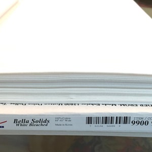 May include: A roll of white bleached Bella Solids cotton fabric, 44-45 inches wide. The fabric is from Moda Fabrics, item/color 9900 98. The label includes the text "Made in Korea".