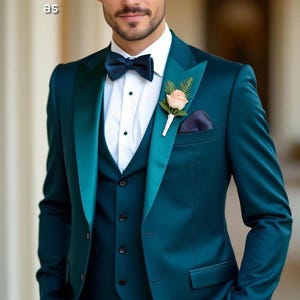 May include: A three-piece teal suit with a satin lapel, bow tie, and pocket square. A white dress shirt and a boutonniere complete the formal ensemble. The text "HussainbyAn as" is visible in the image.