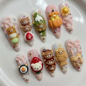 May include: A set of three ceramic mugs with a speckled, matte finish. The mugs are in shades of cream, light gray, and dark gray. Each mug has a simple, minimalist design and a rounded handle.