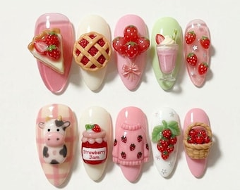 May include: A collection of ten artificial nails, each adorned with miniature, colorful, and whimsical designs. The nail art features strawberries, a cow, a pie, a milkshake, and a basket, all in a playful, cute style.