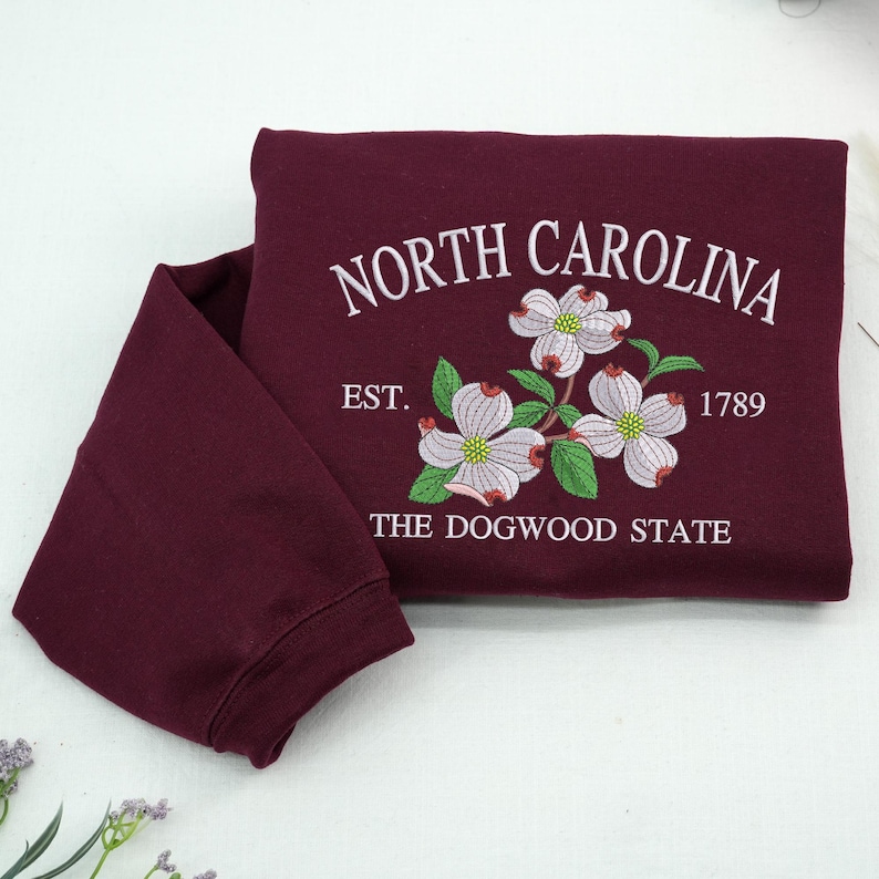Embroidered Dogwood flower on maroon sweatshirt