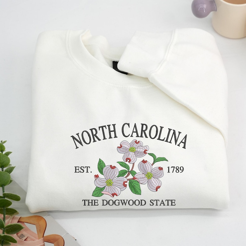 Embroidered Dogwood flower on white sweatshirt