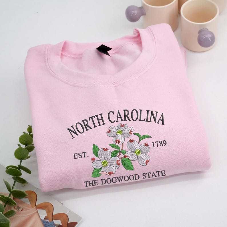 Embroidered Dogwood flower on light pink sweatshirt