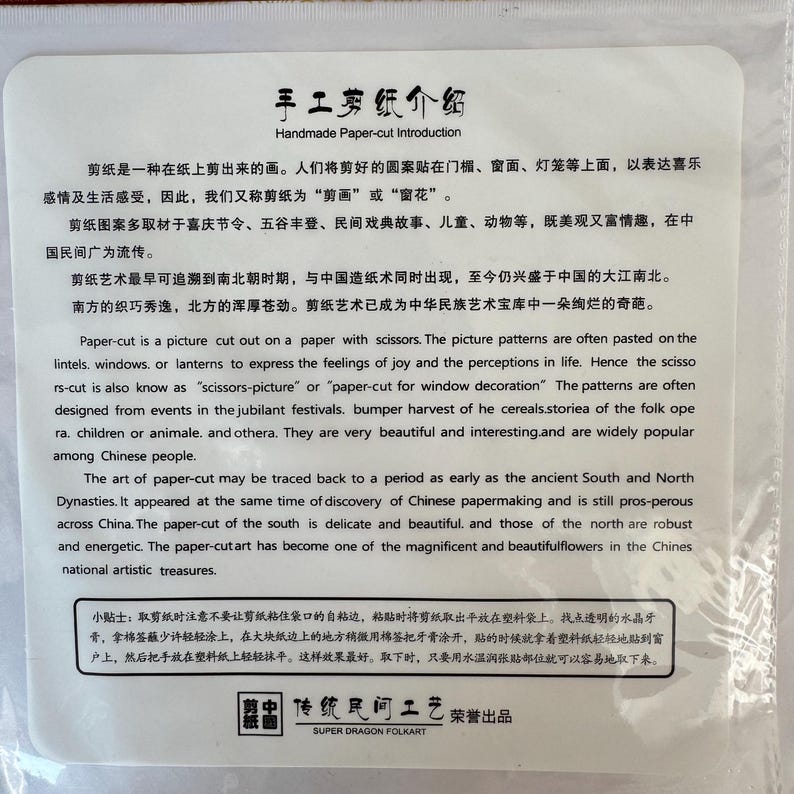 May include: A white paper with Chinese text and English translation about handmade paper-cut art. The text describes the history, techniques, and cultural significance of paper-cut art, including its use in window decorations.