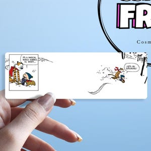 May include: A rectangular sticker featuring comic strip panels of Calvin and Hobbes. One panel shows them standing together, and the other shows them sledding. Text includes "It's a magical world, Hobbes, ol' buddy..." and "Let's go exploring!"