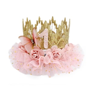 organza butterfly with rhinestone detail, blush pink roses, and blush pink ruffled tutu trim with gold stars. Perfect for baby girl first birthday, cake smash photoshoot, and fairy princess theme. Handmade by LoveCrush Crowns®. Can be customized in any age.