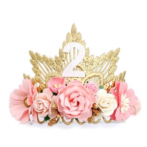 May include: Gold crown with pink flowers and a white glitter number 2 on top. The crown is decorated with gold lace and beads.