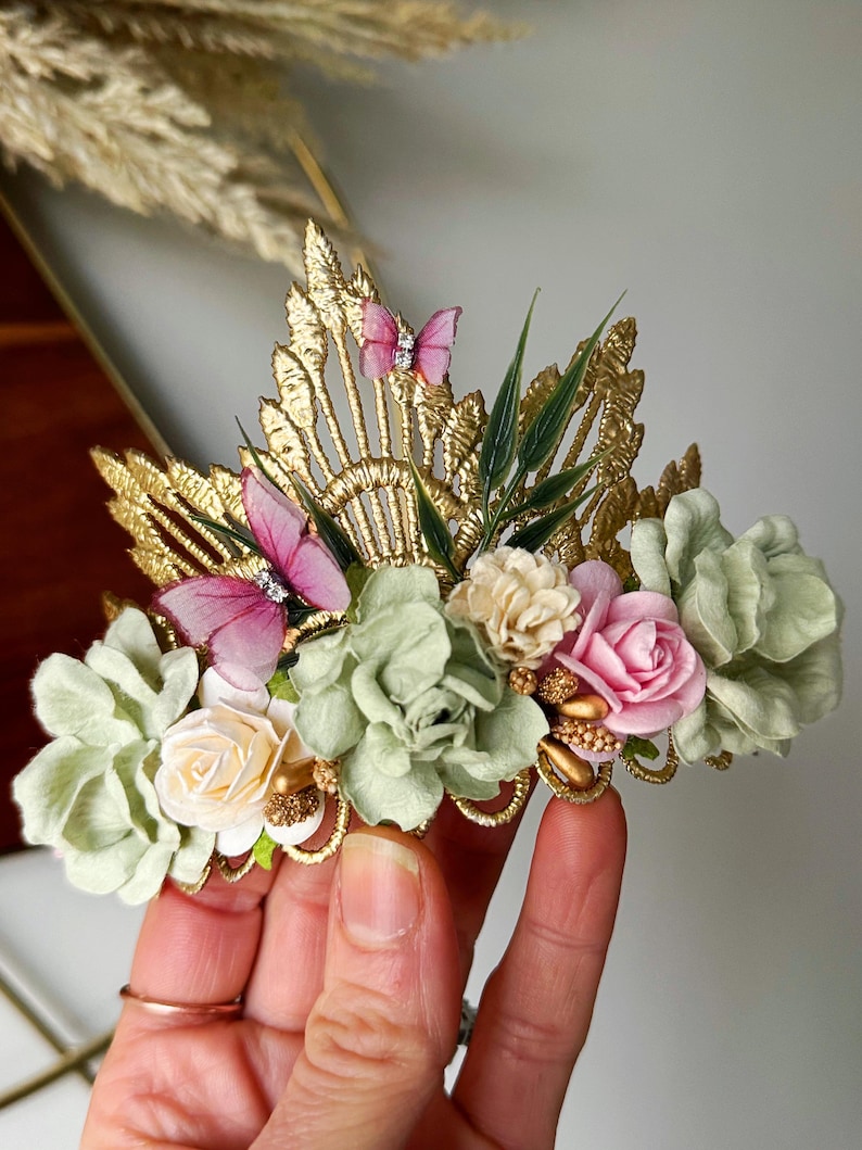 Gold lace tiara adorned with sage green, soft pink, and ivory faux flowers, delicate organza butterflies, and golden leaves. Perfect for baby girl or toddler girl fairy-themed birthdays, photoshoots, or special occasions. Handcrafted with attention to detail for a whimsical and elegant boho look.