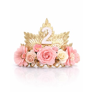 Second birthday crown with pink and ivory flowers on reflective white surface, gold floral tiara with glitter number 2, toddler birthday crown, girl cake smash crown, princess party headband, age 2 photo prop, handmade birthday tiara, made in USA