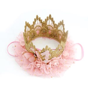 Close-up of handcrafted gold lace first birthday crown with a blush pink tutu trim, delicate butterfly accent, and floral details. Designed for baby girls celebrating their milestone with a dreamy princess or ballerina theme. LoveCrush Crowns® makes high-quality handmade crowns for special moments.