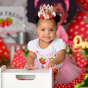 Pink lace strawberry first birthday crown with red and blush flowers, glittery strawberry topper, and number one detail. Perfect for a Sweet One birthday, berry first birthday, cake smash photoshoot, or toddler party hat. Handmade and customizable.