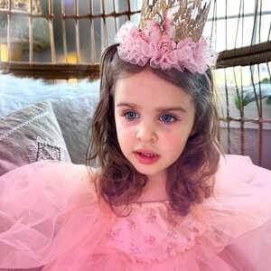 Handmade first birthday headband featuring a gold lace crown with blush pink tulle tutu trim, butterflies, and flowers. A must-have for milestone celebrations, fairy princess parties, and dress-up play. LoveCrush Crowns® is known for its elegant handcrafted crowns.