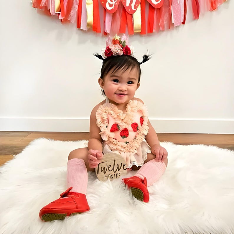 Handmade pink lace strawberry birthday crown with floral accents, glitter details, and a whimsical design, perfect for a toddler’s first birthday outfit, cake smash, and dress-up.