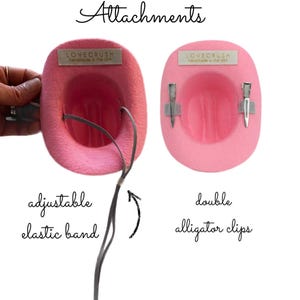 May include: Pink cowboy hat attachments with the text "LOVE CRUSH handmade in the USA". One hat has an adjustable elastic band, and the other has double alligator clips. The word "Attachments" is written above the hats.