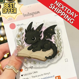 May include: A black dragon illustration with star accents, resting on an open book, set against a floral background. The image is on a social media-style card with the text "Instagram", "Album", and "BEST OFFER".