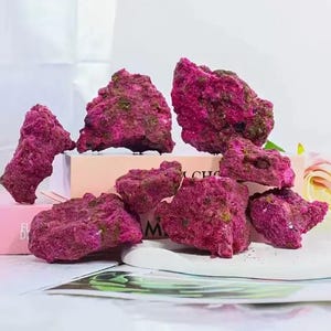 May include: A white ceramic mug with a black handle and the text "But First, Coffee" in a bold, black font. The mug is set against a neutral background, highlighting its simple design.