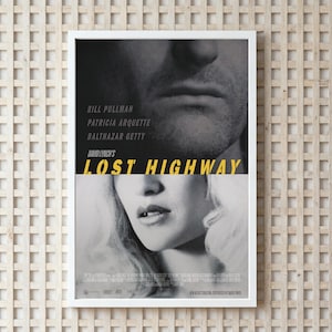 May include: A framed movie poster for "Lost Highway" by David Lynch. The poster features a black and white image of two faces, with the title in yellow. The cast includes Bill Pullman, Patricia Arquette, and Balthazar Getty.