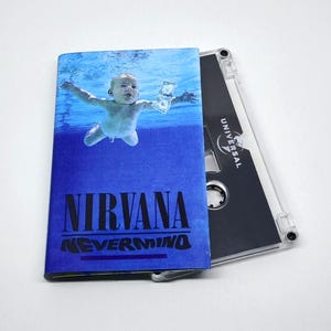 May include: A cassette tape featuring the album artwork for Nirvana's "Nevermind." The cover shows a baby underwater, reaching for a dollar bill. The album title is in bold letters, with the band's name above it.