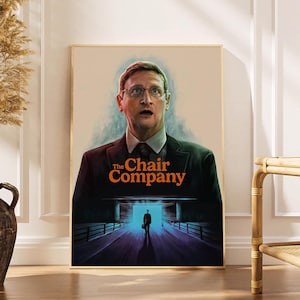 May include: A framed poster featuring a man in a suit with glasses, the title "The Chair Company" in orange text. The poster has a surreal, cinematic style, with a figure in a tunnel.