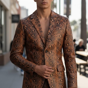 May include: A brown and black snakeskin-patterned blazer with a single-button closure. The blazer has a notched lapel and two front pockets. The image is taken outdoors, with a blurred background of a street scene.