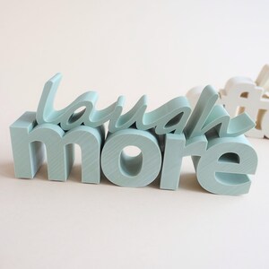 Motivational Laugh more sign printed decor created using commercial STL 3D printer files.