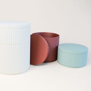 3D printable storage boxes STL files used as desk organizer containers.