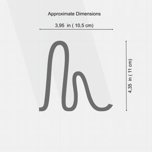 May include: A gray, abstract design with approximate dimensions of 3.95 inches (10.5 cm) wide and 4.35 inches (11 cm) tall. The design has a flowing, curved shape.