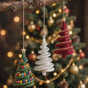 May include: Three hanging crochet Christmas tree ornaments in green, white, and red. The green tree features multicolored beads, the white tree has silver beads, and the red tree has gold beads. Each ornament is topped with a small star.