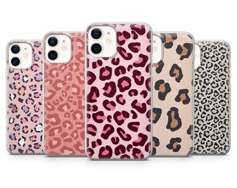 May include: A collection of five phone cases with a leopard print design. The cases feature a variety of colors, including pink, brown, and tan. The leopard spots vary in size and shape, creating a unique pattern on each case.
