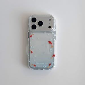 May include: Clear phone case with a design of red goldfish swimming in a blue-toned background with bubbles. The case has a clear border and a silver camera section. The text "Echoes resonate" is printed on the case.