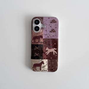 May include: A clear phone case with a patchwork design featuring horses, bows, and mushrooms in shades of brown, pink, and purple. The case has a glossy finish and a camera cutout.