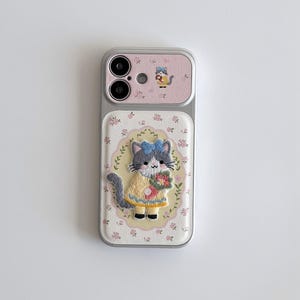 a phone case with a cat design, including a pink background and a small cat illustration.