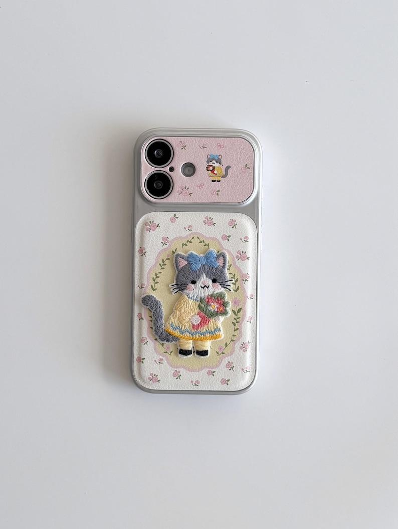a phone case with a cat design, including a pink background and a small cat illustration.