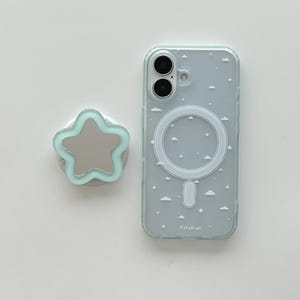 May include: A light blue phone case with a cloud and star pattern, and a matching star-shaped phone grip. The phone case has a circular magnetic charging area. The text "Cerulean" is printed on the case.