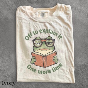 Vintage Grumpy Frog Reading T-Shirt | Funny Teacher Shirt for Explaining It One More Time | Retro Classroom Tee