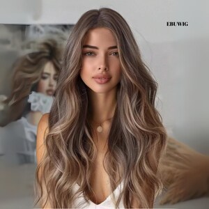 May include: A long, wavy wig with a blend of brown and blonde highlights. The hair cascades down, framing the face. The wig has a natural look, with a subtle shine. The text "EBUWIG" is visible in the upper right corner.