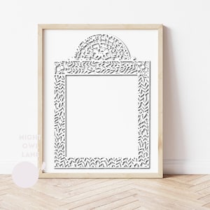 May include: A white, intricately cut paper frame with a decorative top arch, set within a light wood frame. The frame features a detailed leaf and floral design, perfect for displaying art or photos. The Night Owl Lane logo is visible in the lower left corner.