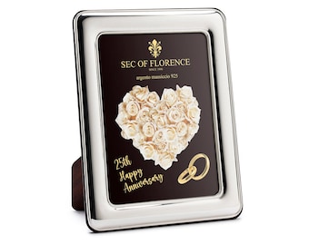 May include: Silver picture frame with a black background and a heart made of white roses. The text "25th Happy Anniversary" is written in gold lettering. The frame is made by Sec of Florence and is made of sterling silver.