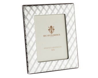 May include: A silver picture frame with a diamond pattern design. The frame has the text "SEC OF FLORENCE" and "ARGENTO MASSICCIO 925" on it.