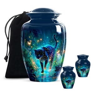 May include: A dark blue urn with a glossy finish, featuring a vibrant illustration of a black cat with a starry pattern. The cat is depicted walking in a mystical, glowing environment. Includes a matching black drawstring bag and two smaller urns.