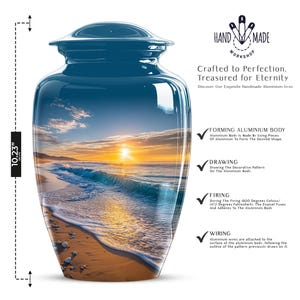 May include: A blue, handmade aluminium urn, 26 cm tall, with a scenic beach sunset design. The urn has a lid and features text that reads "Crafted to Perfection. Treasured for Eternity."