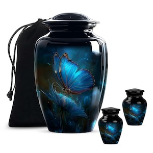 May include: A dark blue cremation urn with a large, vibrant blue butterfly design. The butterfly is perched on a blue flower against a dark, starry background. Includes two smaller matching keepsake urns and a black velvet bag.