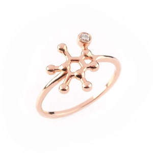 Caffeine Molecule ring in Rose Gold, with a Diamond set on it. Thin rounded ring band with polished finish.