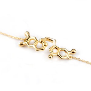 Bracelet in Yellow Gold featuring the Serotonin molecule. Polished finish and thin link chain.