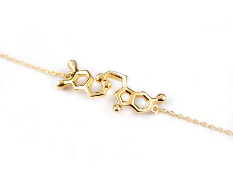 Bracelet in Yellow Gold featuring the Serotonin molecule. Polished finish and thin link chain.